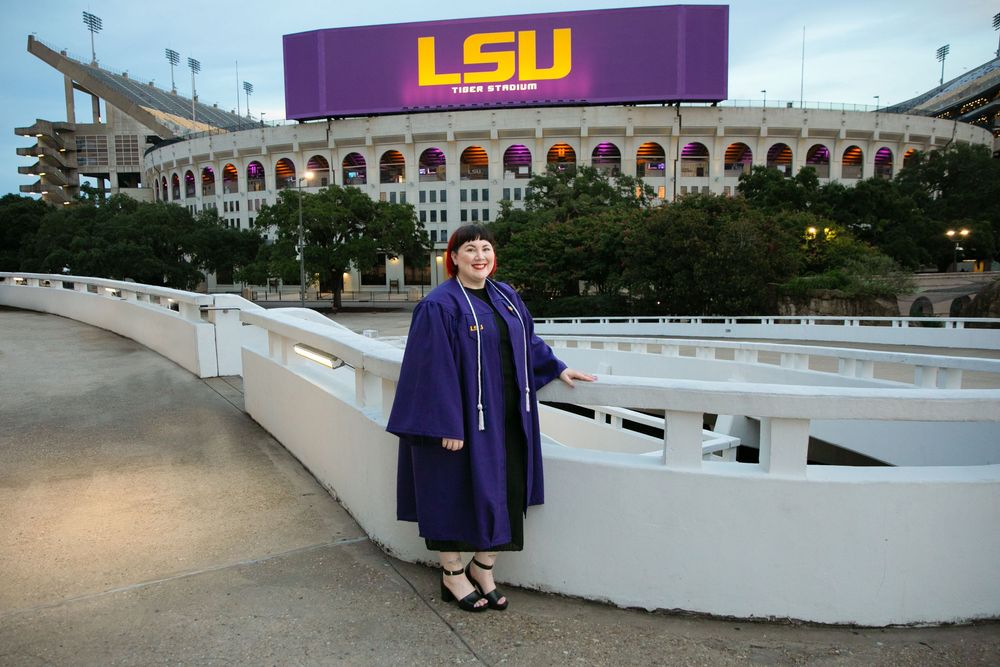 LSU graduation picture in front of the LSU marquee