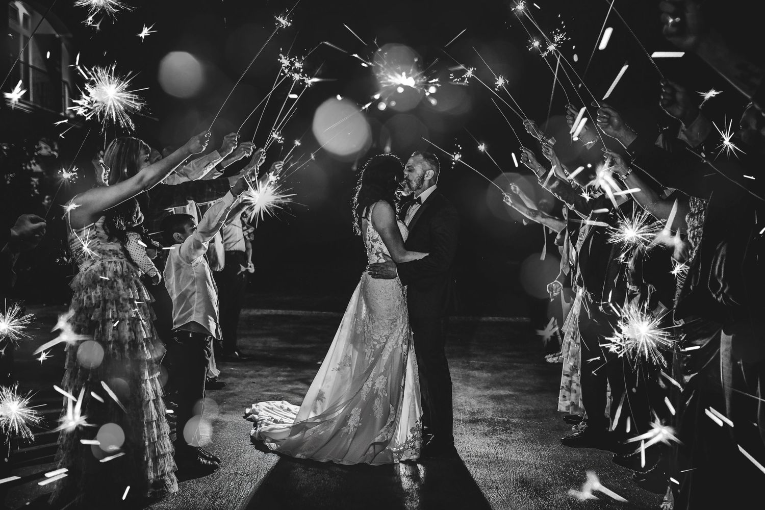 Bride and groom running through a sparkler exit at D’Vine Grace Vineyard in McKinney, Texas