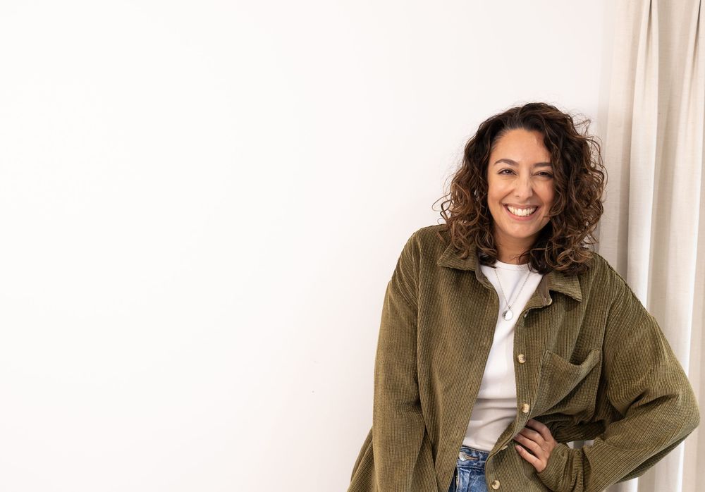 Lifestyle photos showing person in olive green jacket against neutral background. Photography in Buckinghamshire.