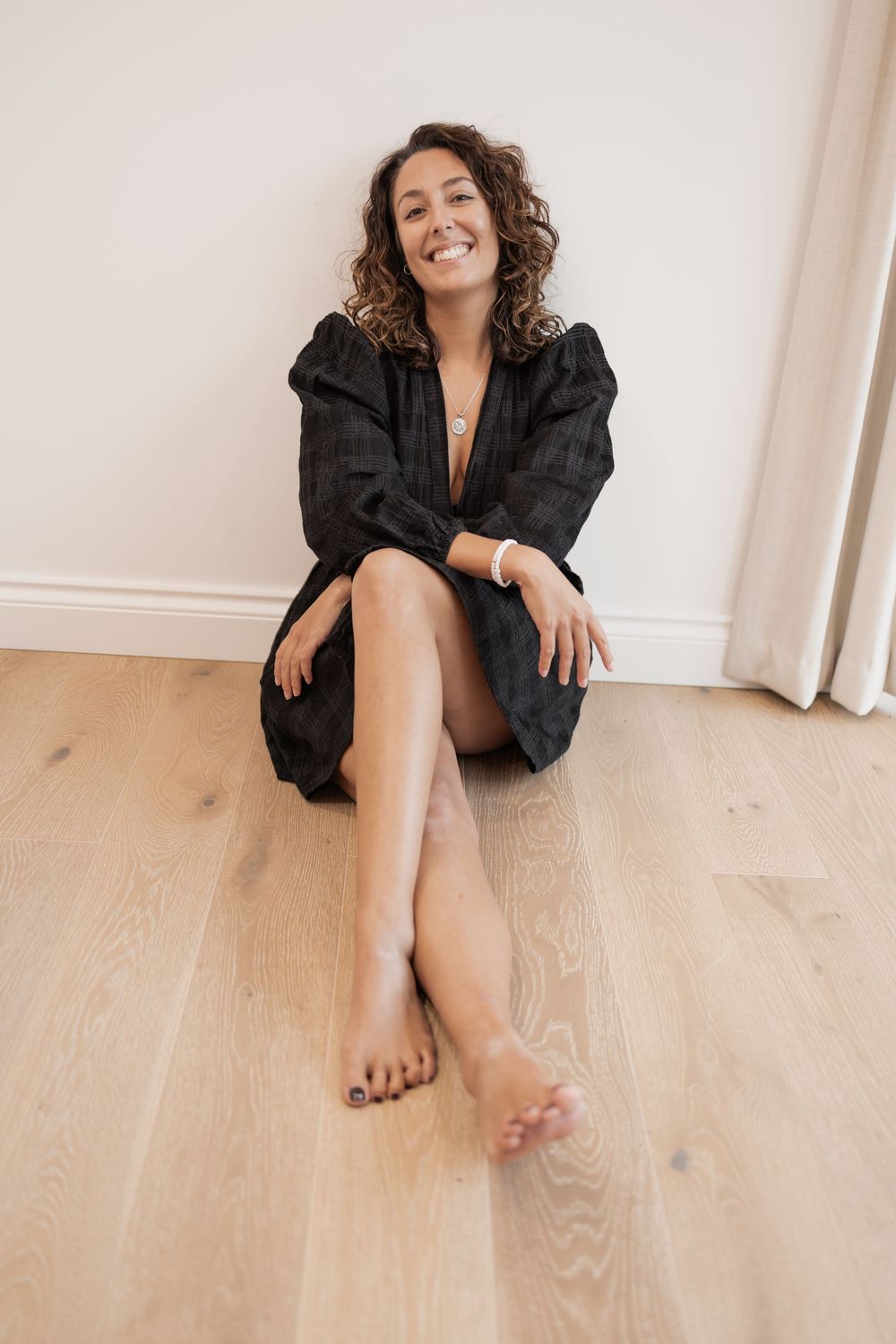 Relaxed lifestyle portrait session on light wooden floors against white wall. Photography in Buckinghamshire.