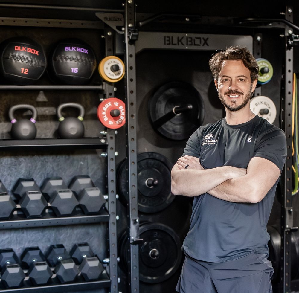 Fitness equipment storage area with kettlebells, dumbbells and weights displayed on shelves in a gym setting. Photography in Buckinghamshire
