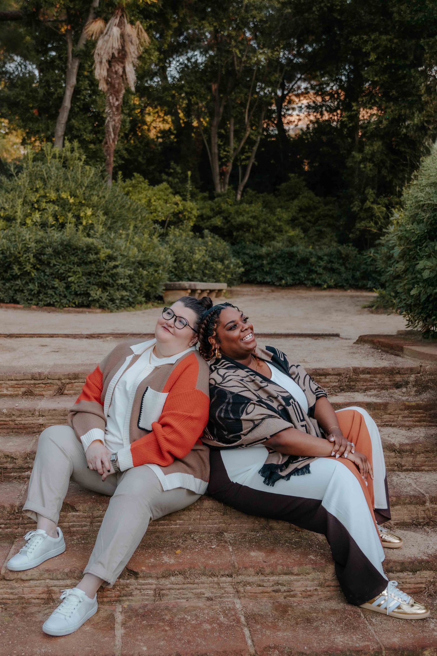 Surprise proposal moment with Jenna on one knee in a sunny garden.