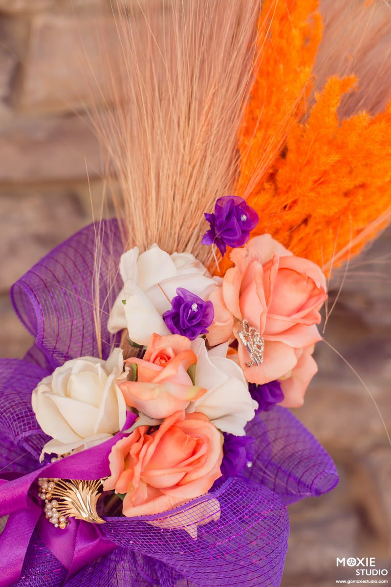 Close-up sequence of a decorative corsage with peach and purple flowers against a blurred background.