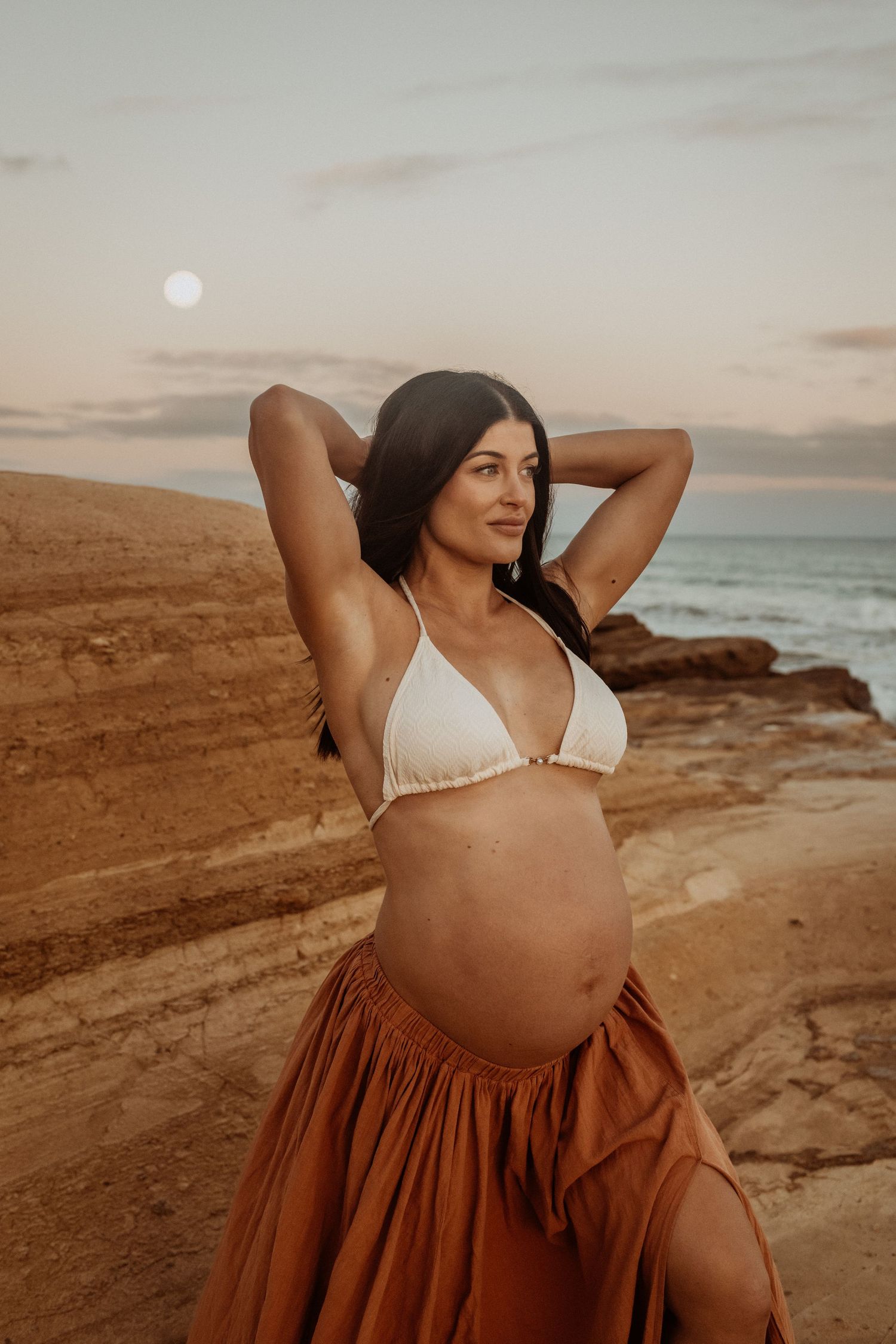Photoshoot of cream bikini on maternity model at a Surfcoast Beach during sunset. Geelong, Australia