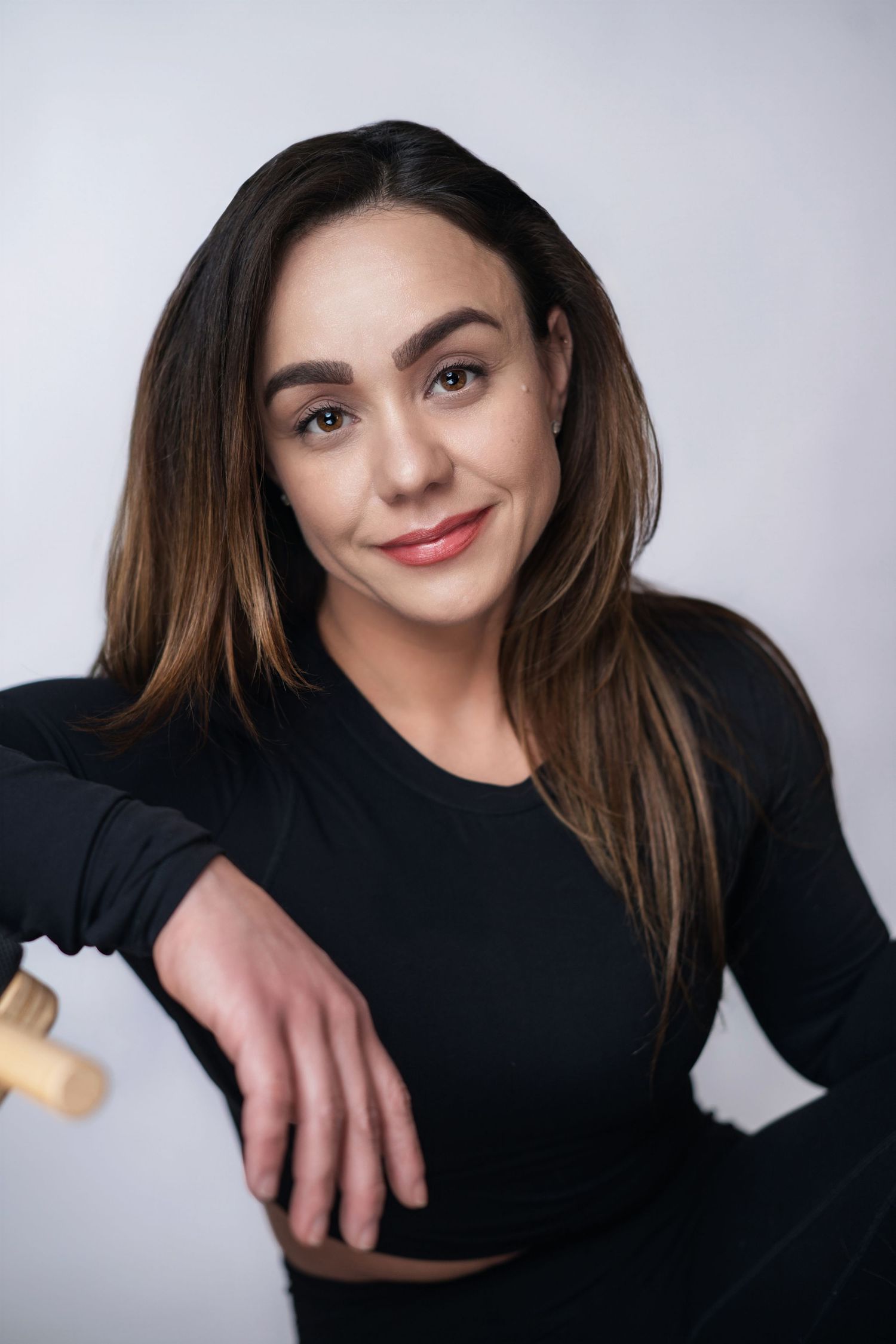 A series of artistic portrait shots showing someone in a black top against a light background.