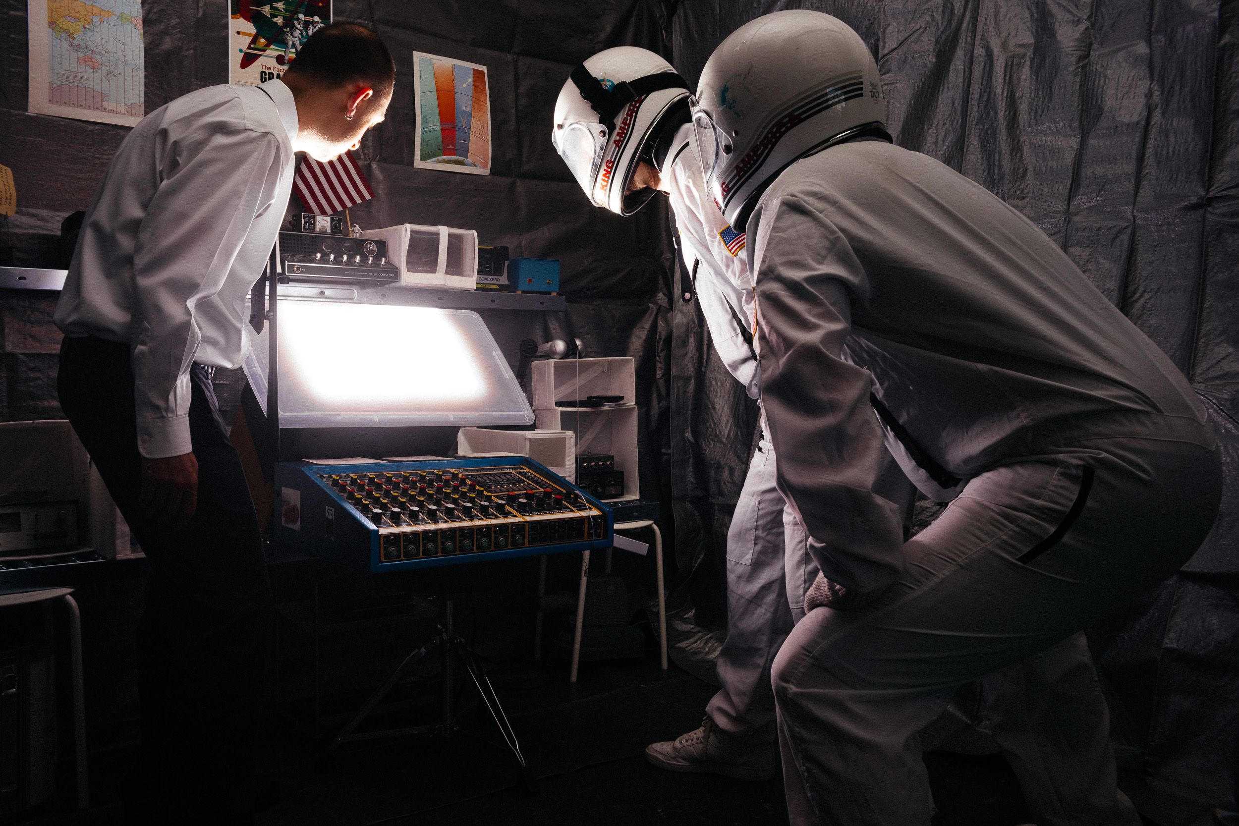 Professional chefs in white uniforms prepare food in a commercial kitchen setting.