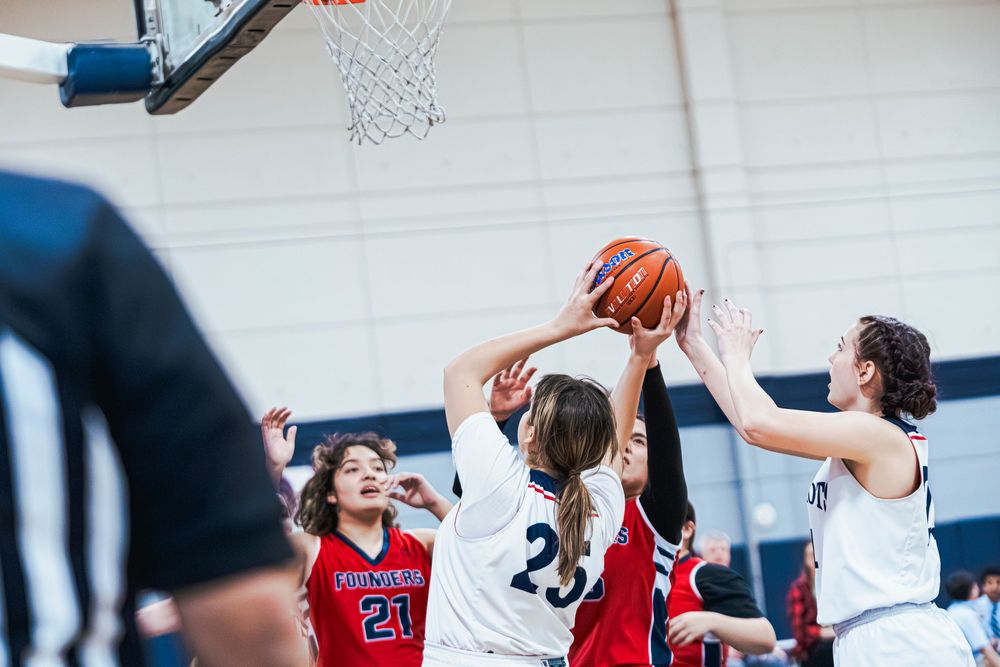 Girls Basketball player throwing up the ball for a basket