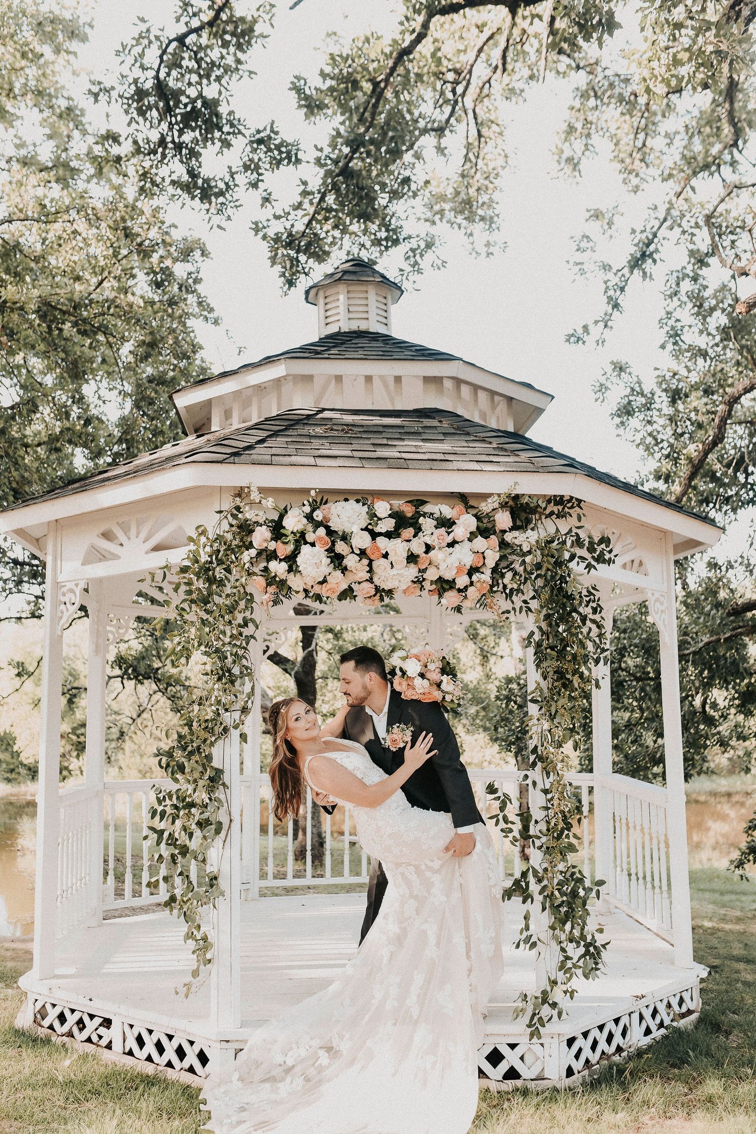 Romantic editorial portrait of bride and groom during their spring wedding at Towering Oaks Wedding Venue.