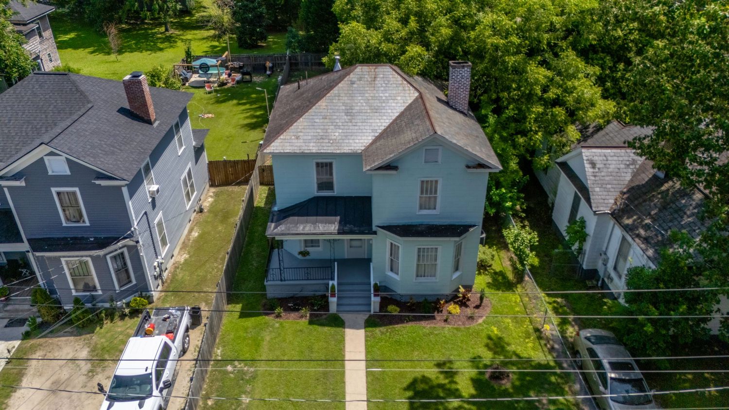 Drone aerial photography of a residential property showing roof, yard, and surrounding homes in Fayetteville, NC