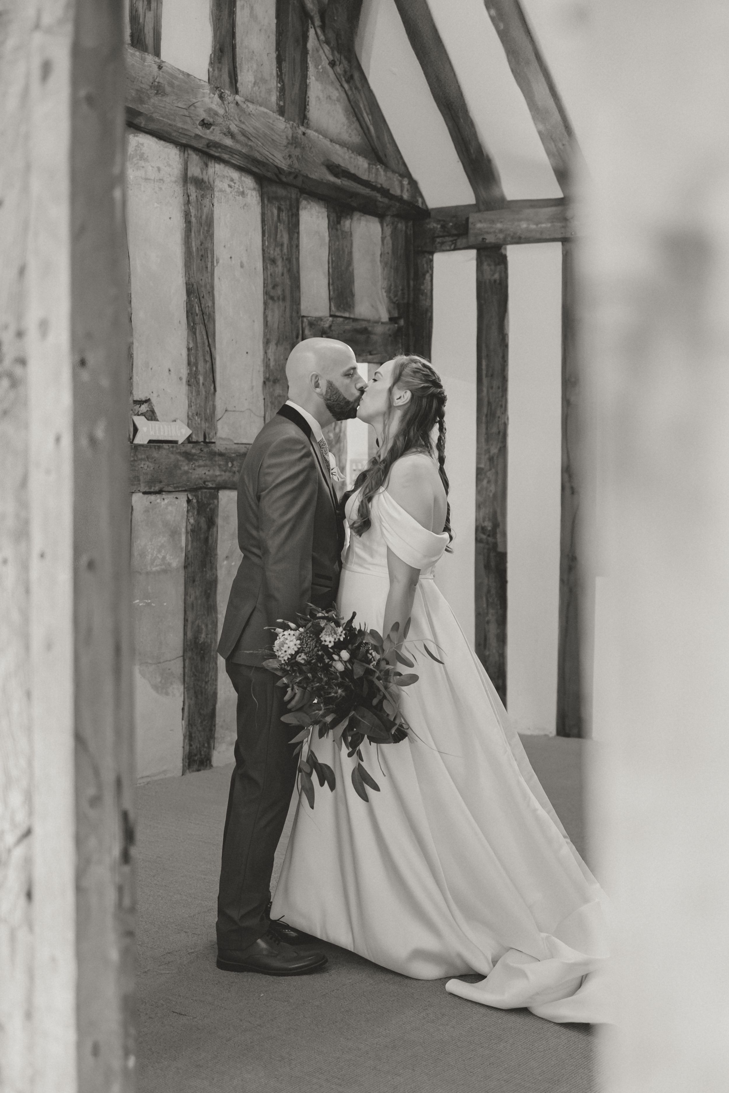 Black and white photo of Bride and Groom sharing intimate moment in historic Cheylesmore Manor House.