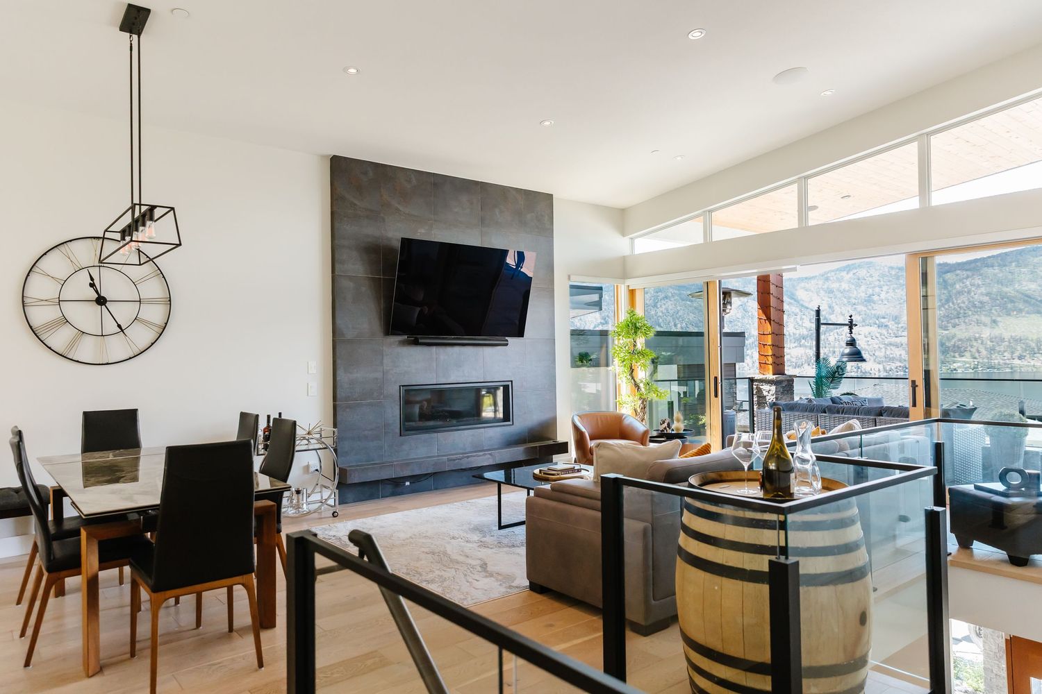 Open concept modern living space with white walls, large windows, and contemporary furnishings in a west Kelowna Airbnb