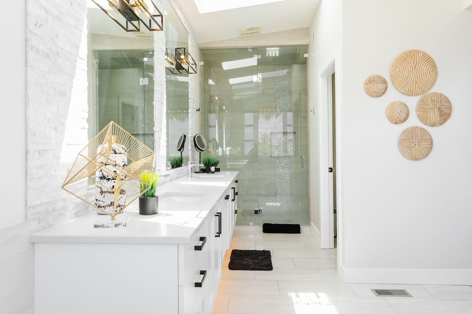 Minimalist bathroom design with white countertops and gold geometric decorative elements in a Kelowna Airbnb