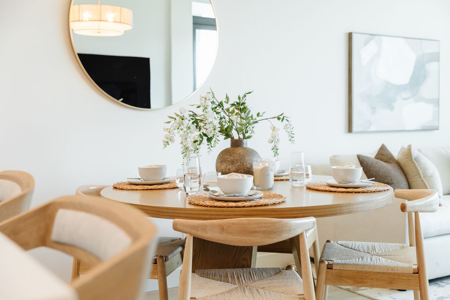 Bright dining area featuring wooden furniture and white walls in contemporary style in a west Kelowna Airbnb