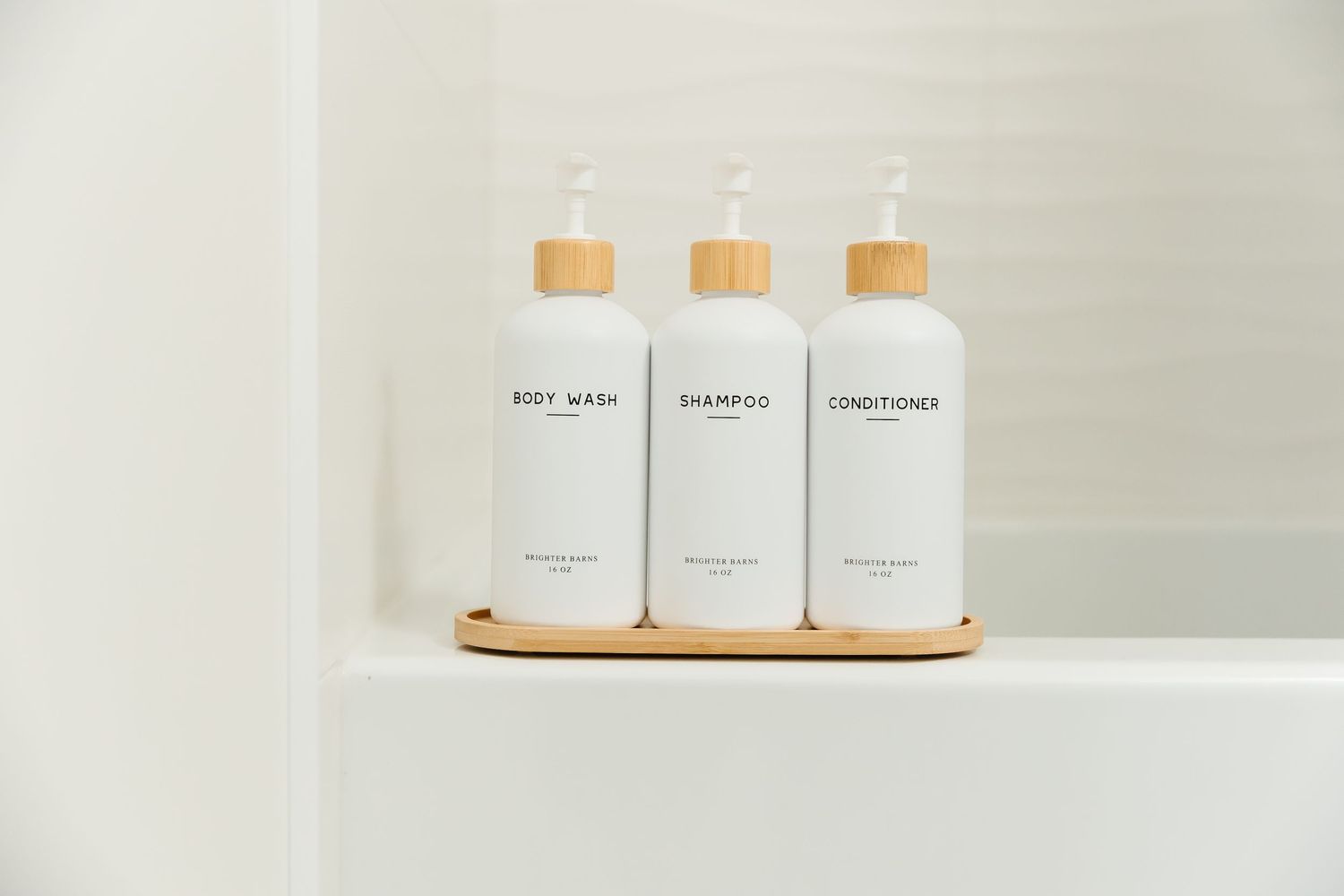 White bathroom toiletries displayed on wooden tray against neutral background in a west Kelowna Airbnb