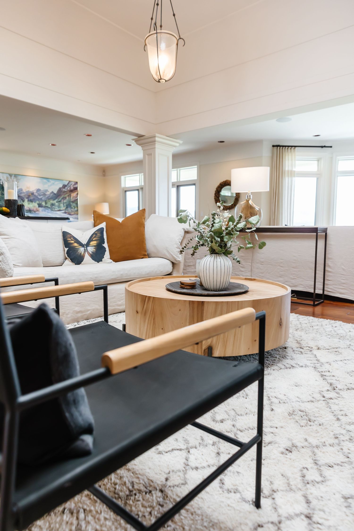 Contemporary living room with black leather chairs and geometric area rug.