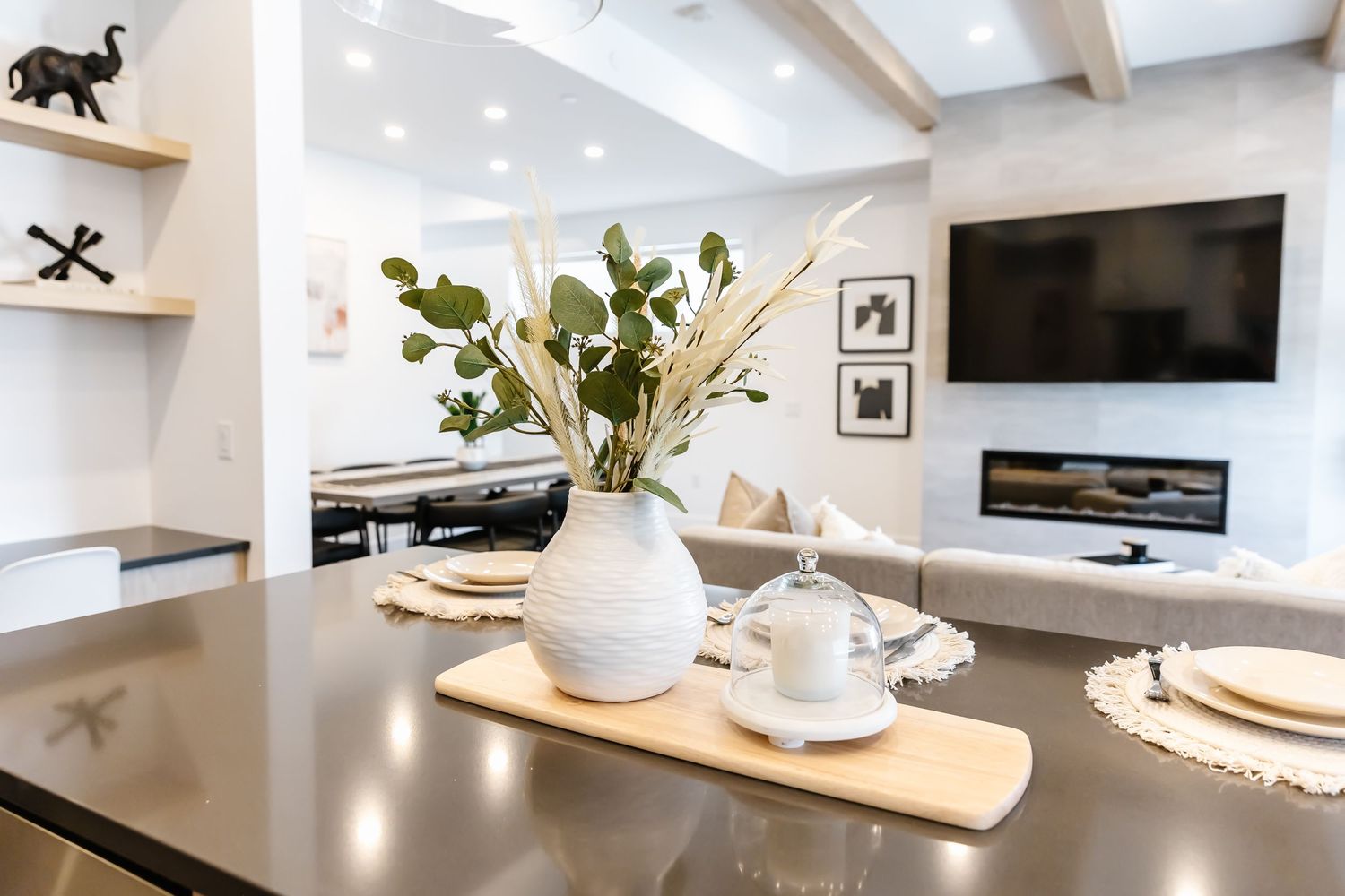 White contemporary kitchen with sleek cabinetry and wooden accents.