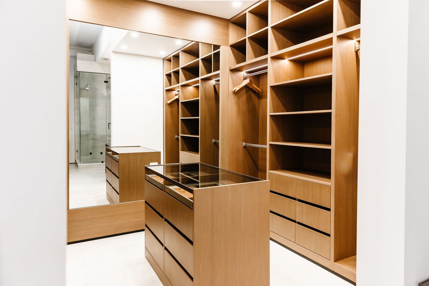 Custom built-in wooden closet system with multiple shelves and storage compartments in a west Kelowna Airbnb