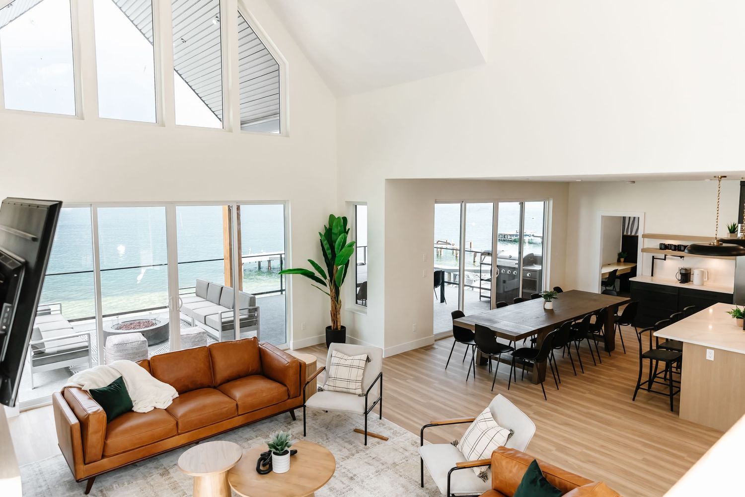 lake living room with panoramic ocean views, leather sofa, and modern furnishings in West Kelowna British Columbia Airbnb photography