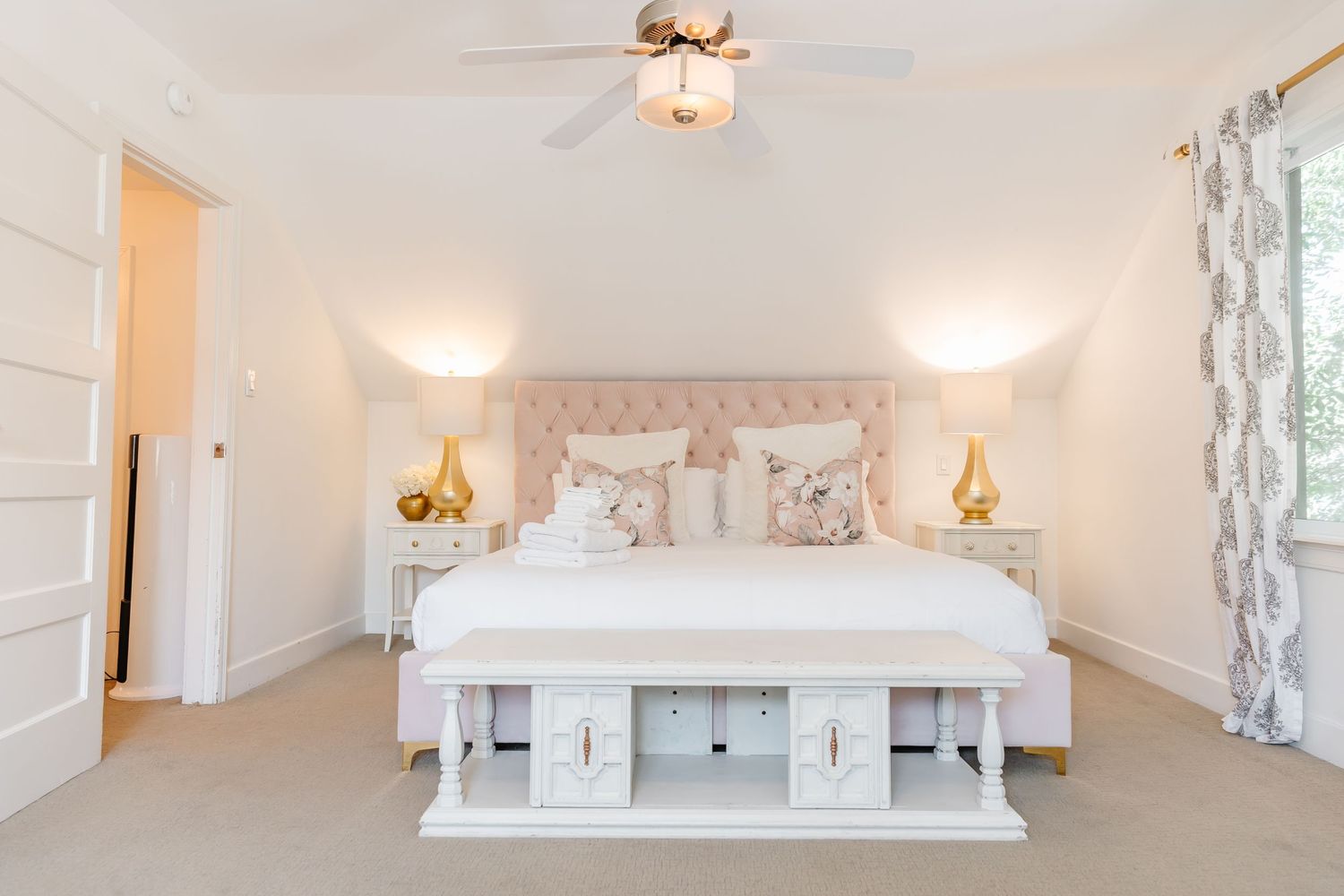 White modern bedroom with minimalist decor and soft lighting.