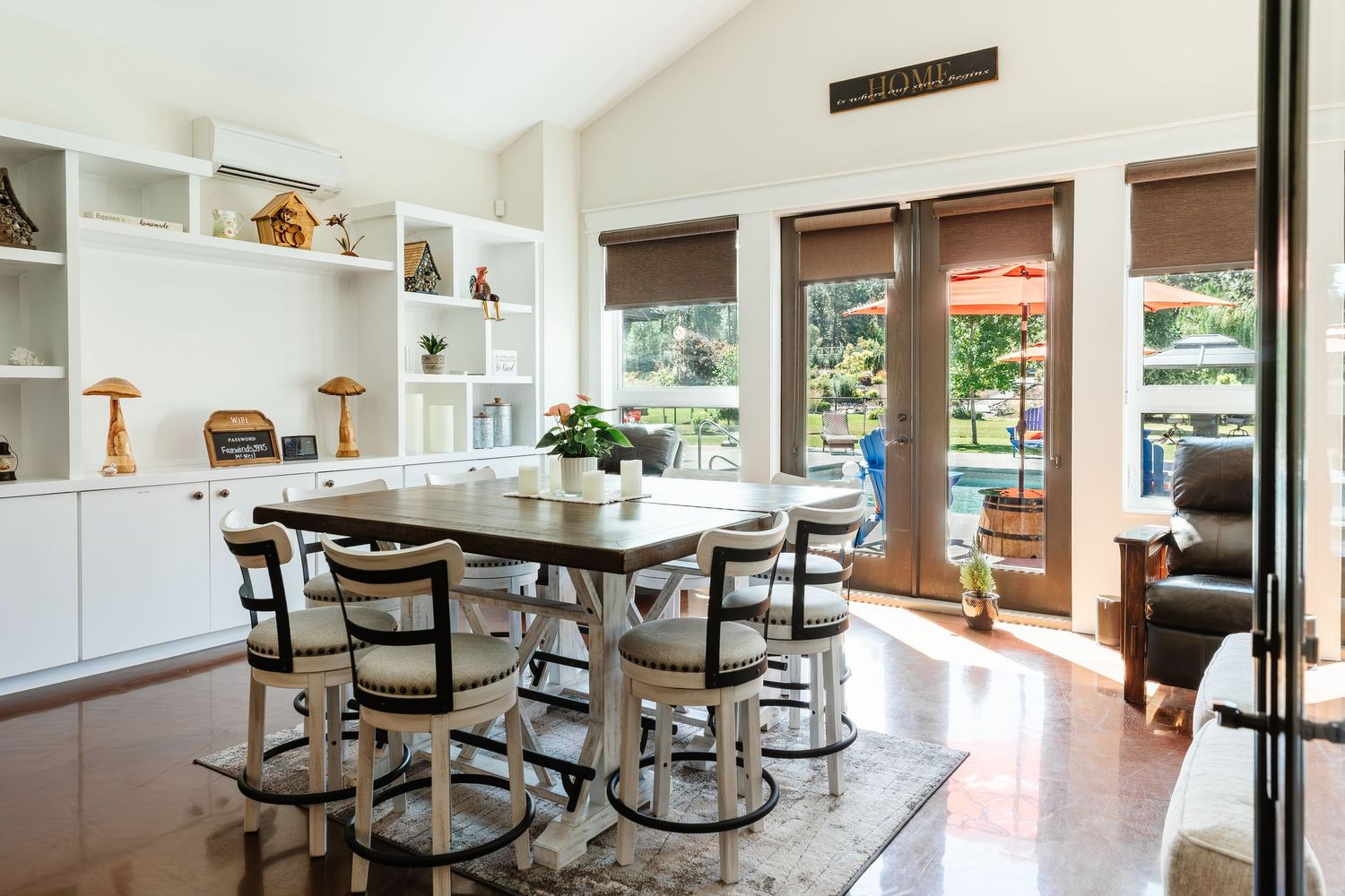 Open concept dining area with pendant lighting and wooden cabinetry in contemporary style.