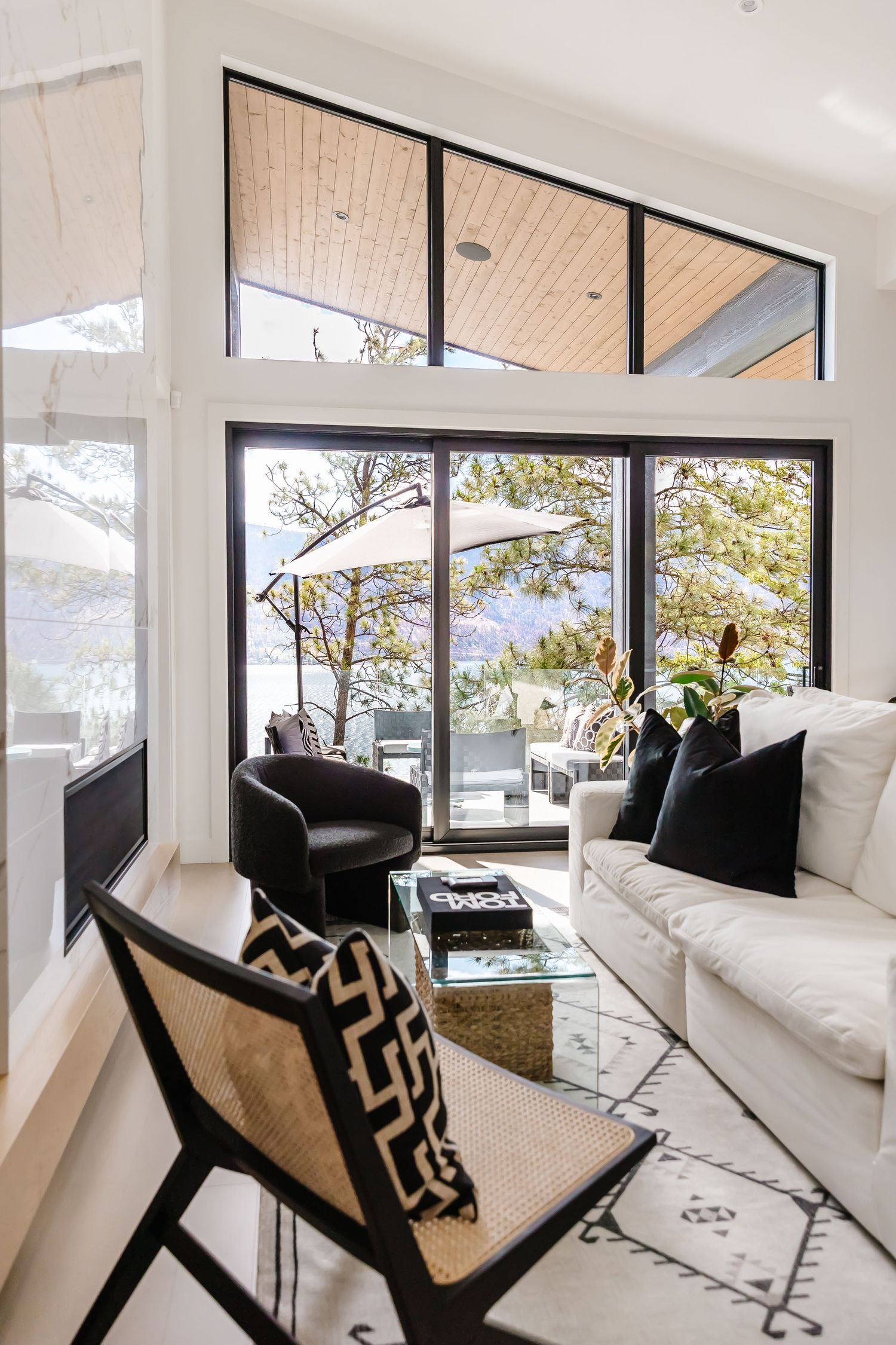 Contemporary living room with mountain views through floor-to-ceiling windows.