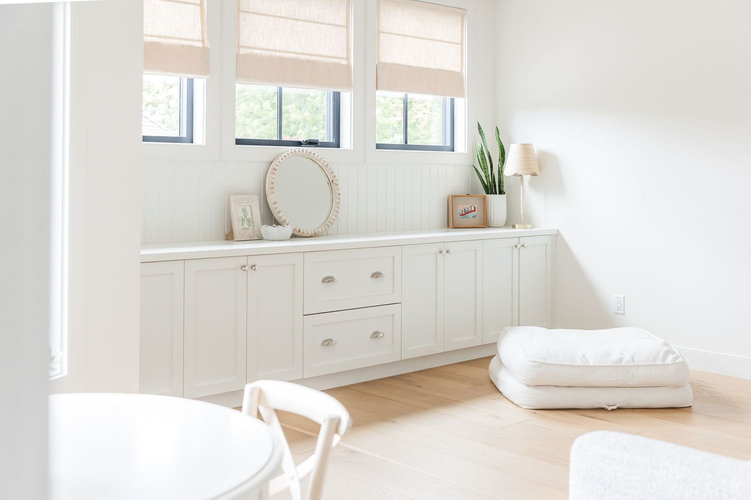 Bright white living space with natural light streaming through windows and minimalist decor in a west Kelowna Airbnb