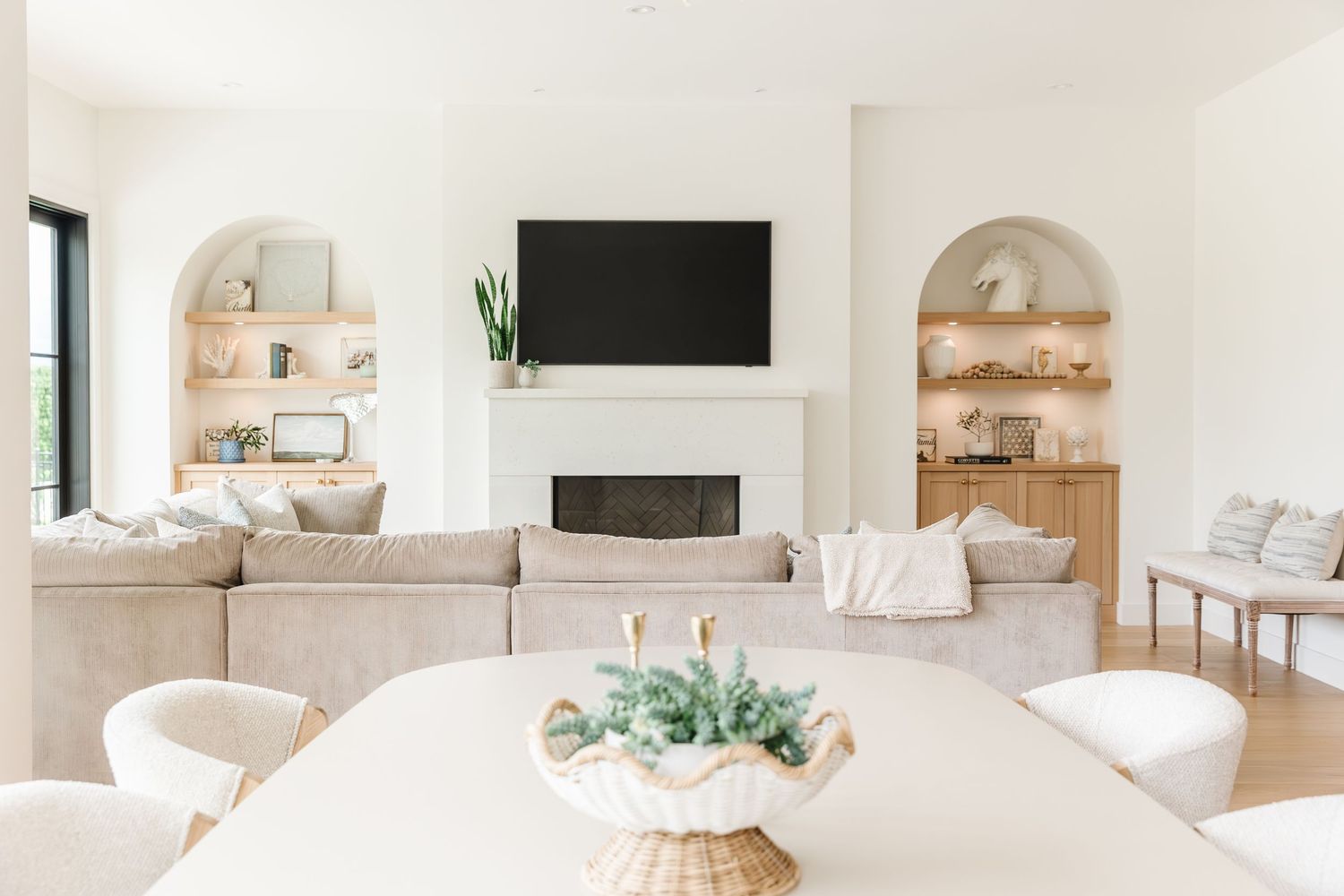 Open concept living space with white walls, arched doorways, and natural wood accents in a west Kelowna Airbnb