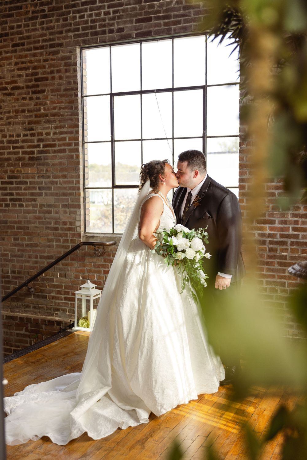 A romantic wedding couple shares intimate moments in The Loft DSM venue in Des Moines, Iowa. Iowa wedding venue and photography