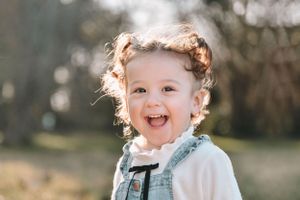 Candid outdoor photography session captures joyful expressions and natural light.