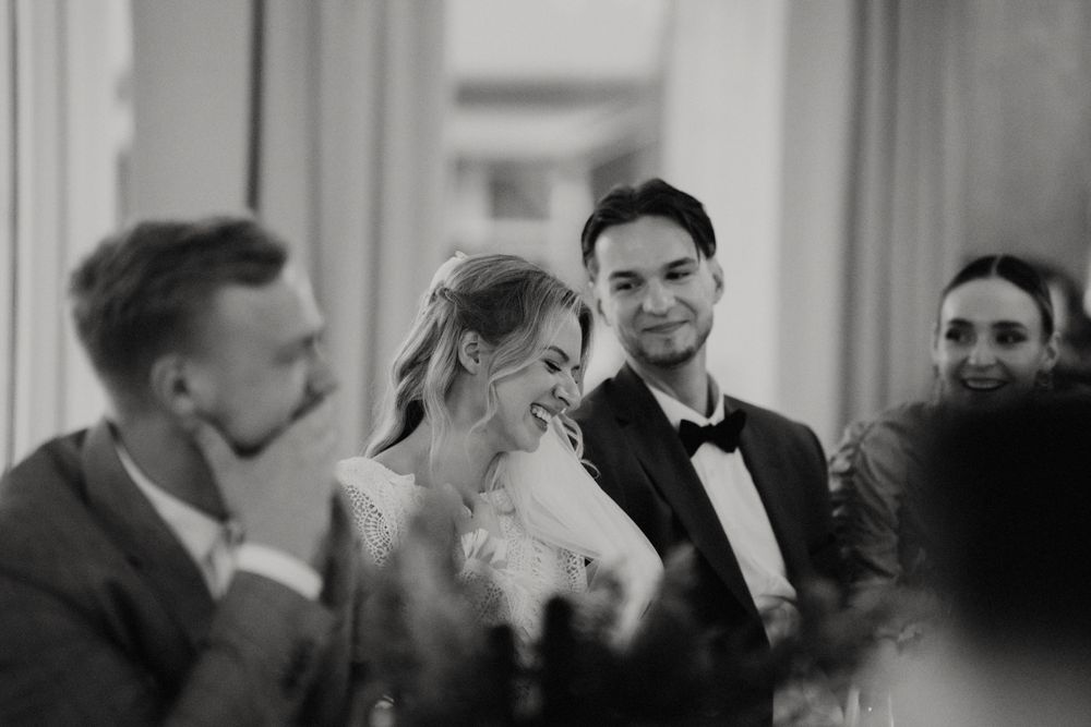 Black and white candid reception photo showing joyful celebration moments.