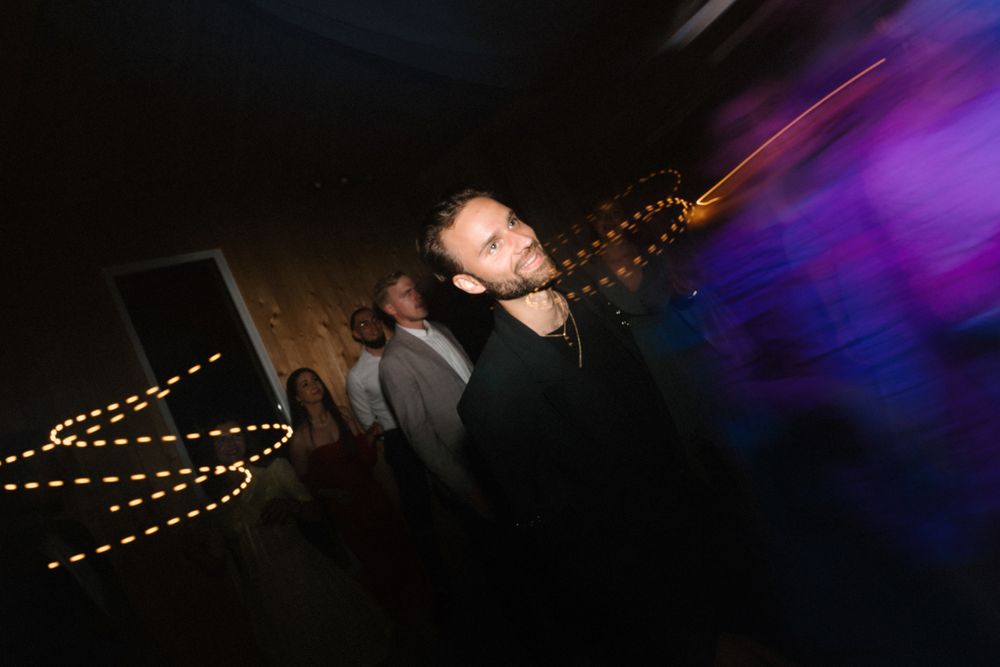Dance floor illuminated with purple lighting and string lights creating a festive atmosphere.