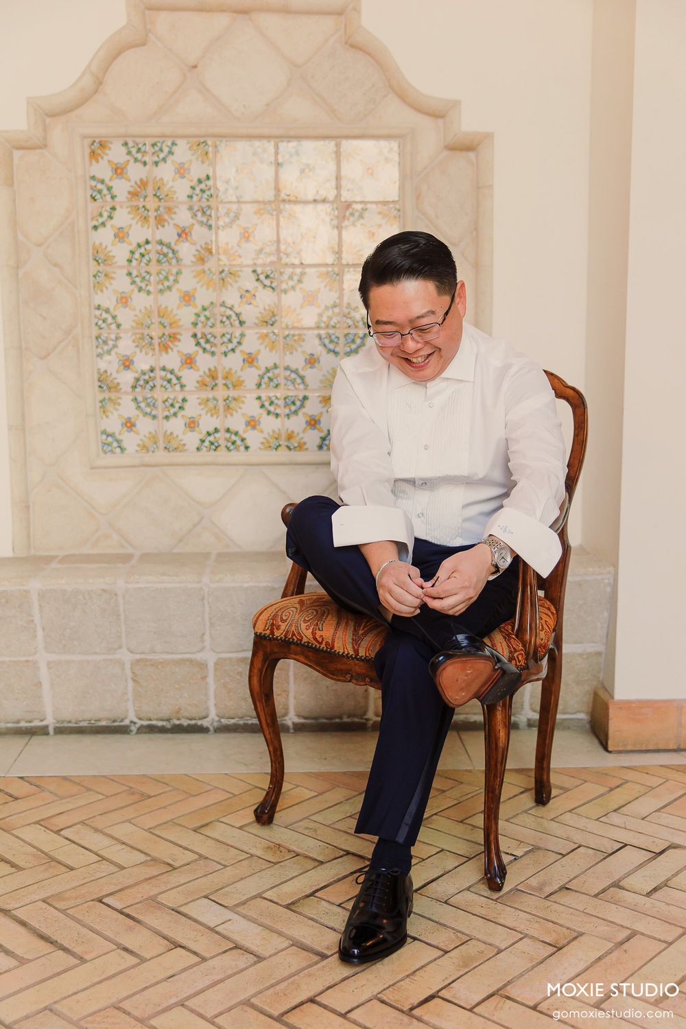 A sequence of candid moments showing a person in white shirt sitting and laughing in an elegant room with patterned walls.