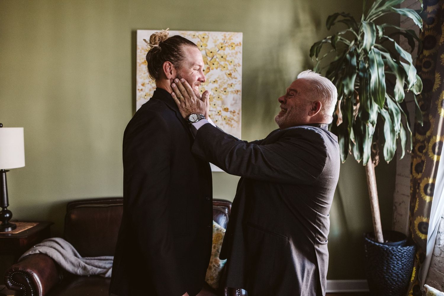 Wedding preparations with natural light streaming through windows in an elegant indoor setting.