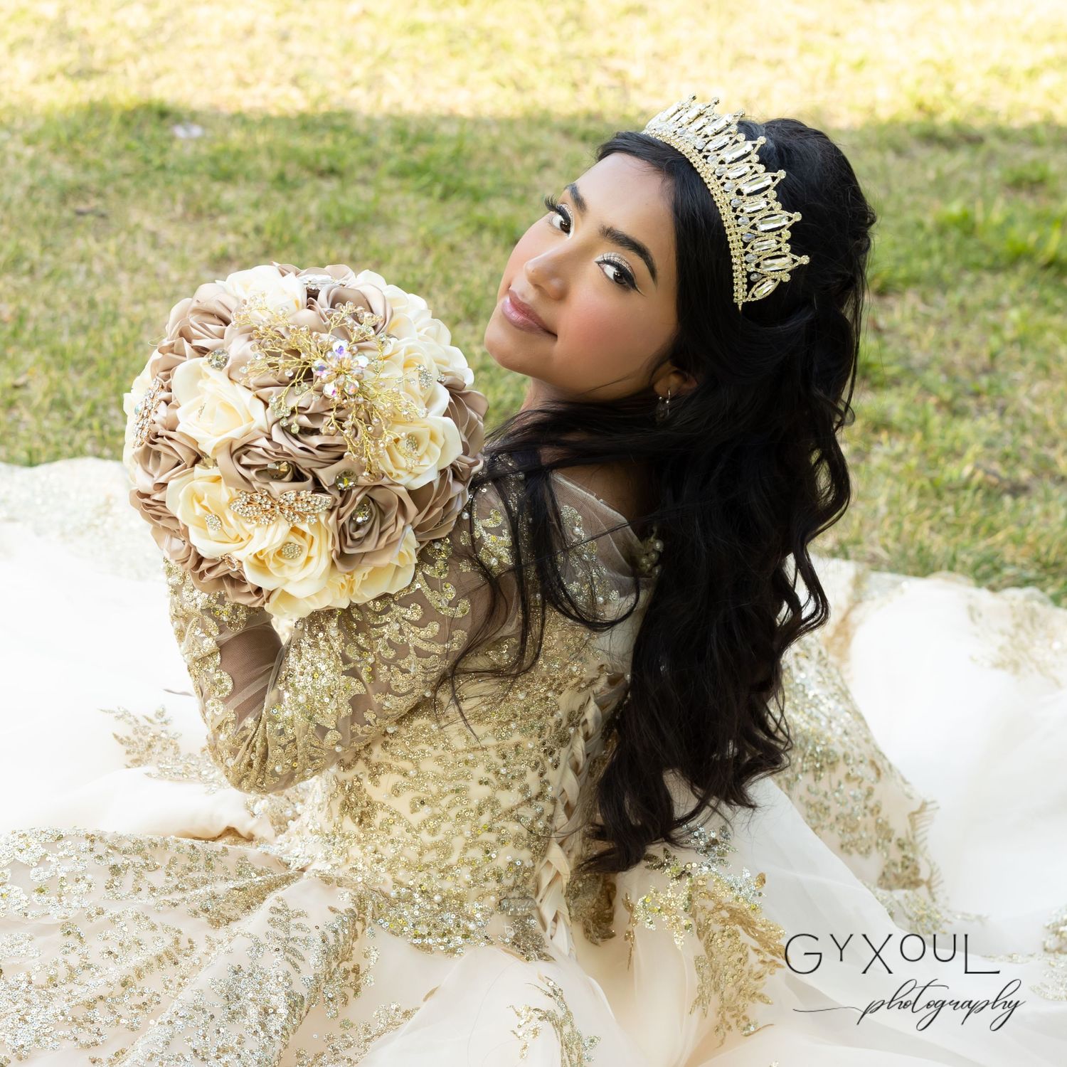 An elegant quinceañera portrait featuring a gold embellished dress and neutral toned bouquet.