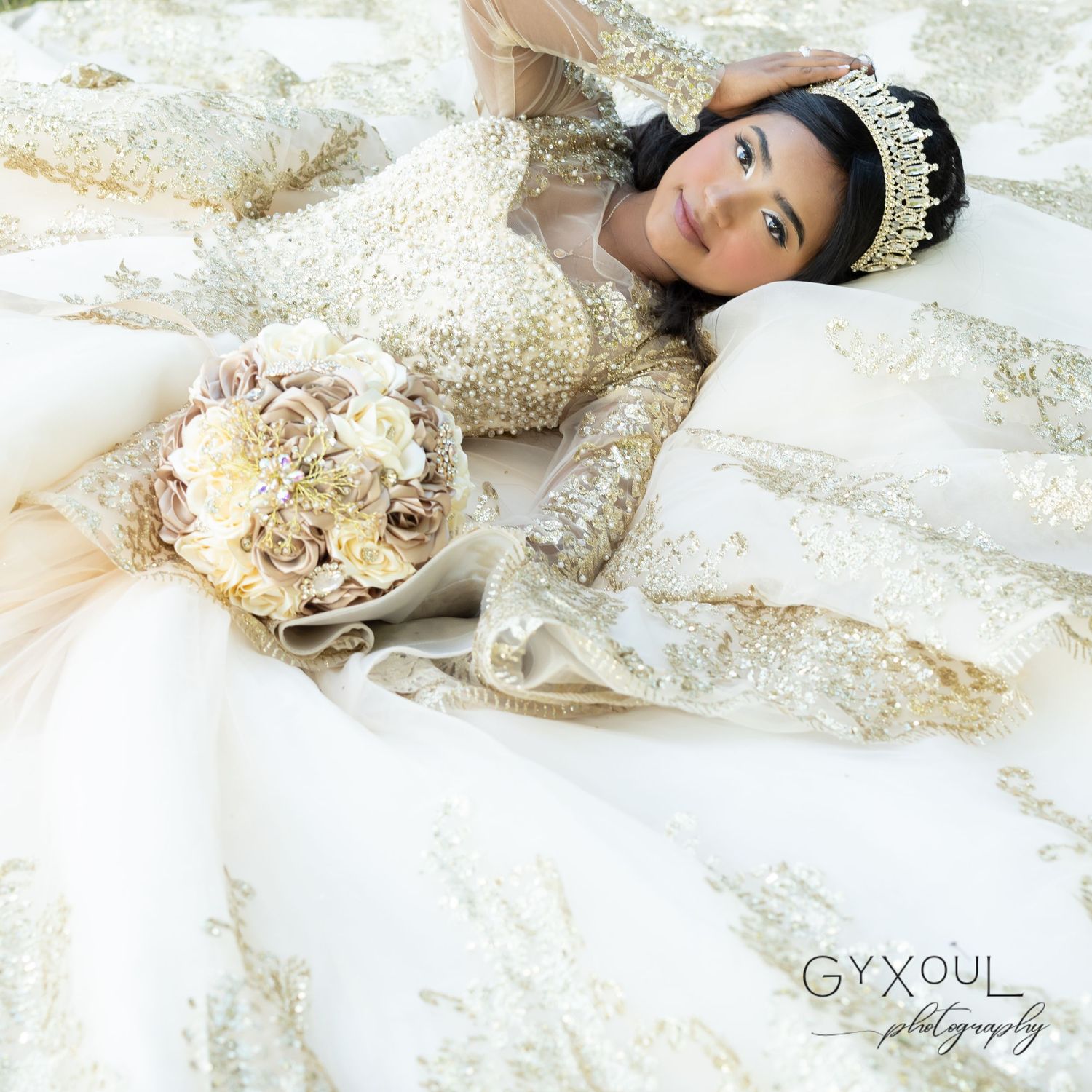 A dreamy quinceañera portrait with a detailed gold gown and neutral floral bouquet.