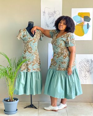 A side-by-side display of a floral mint dress on a mannequin and its styling in a studio setting.