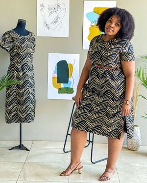 Fashion photo showing chevron print dress on display and being modeled against artistic wall decor.