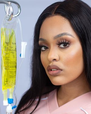 Medical portrait featuring IV drip with yellow solution in the background.