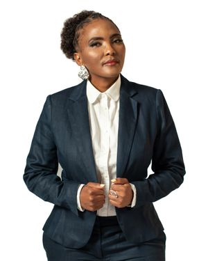 Business portrait in dark suit jacket with white collar shirt and elegant accessories.