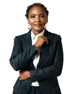 Professional business portrait wearing navy suit and white shirt against neutral background.