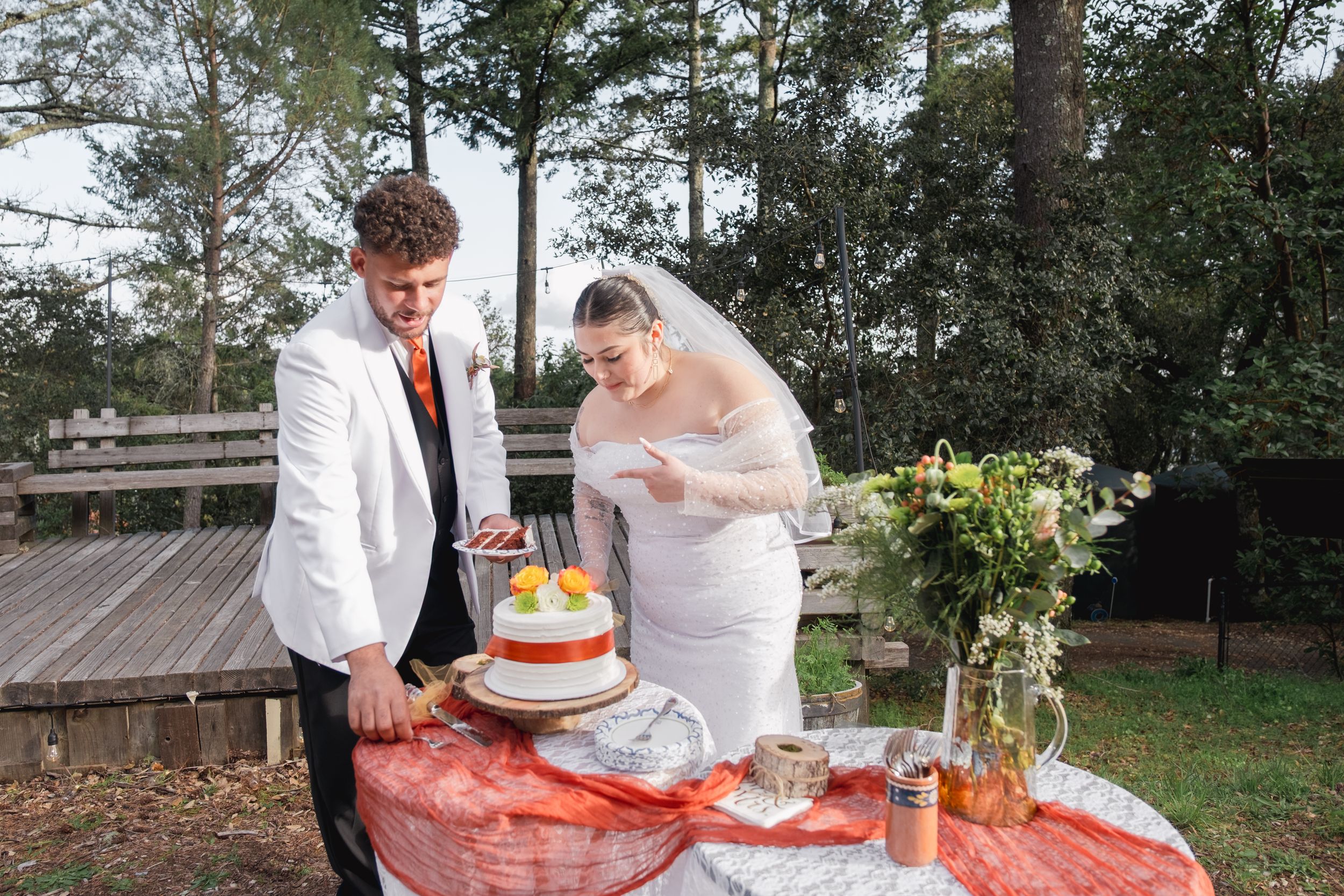 Just married couple, cutting cake.