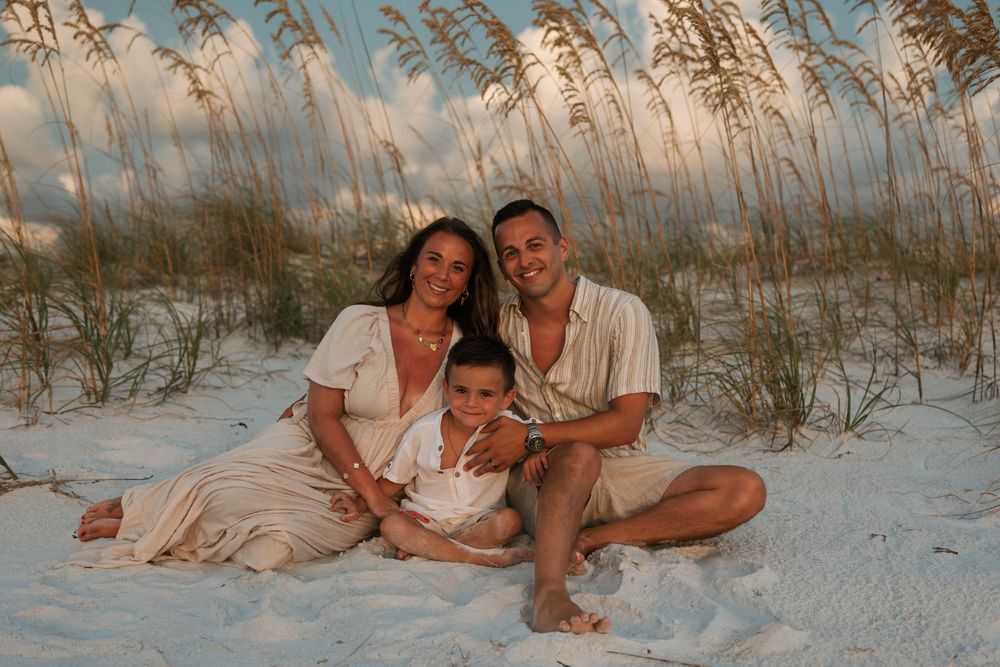 Catching the sunset at the beach, group enjoying quality time together among sand dunes and sea grass.