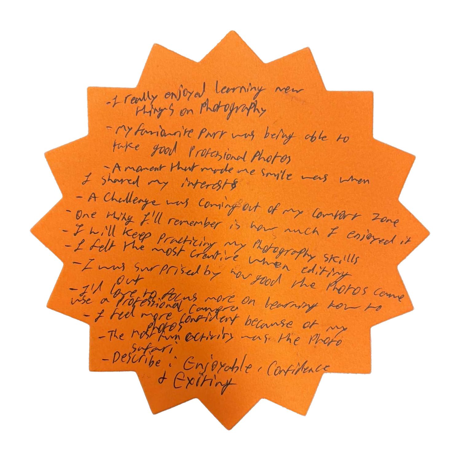 Handwritten notes on an orange starburst-shaped paper.