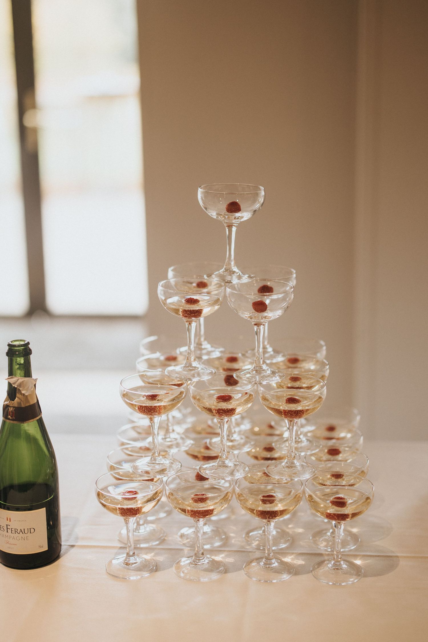A champagne tower made of vintage coupe glasses stacked in a pyramid - taken by Grimsby photographer.