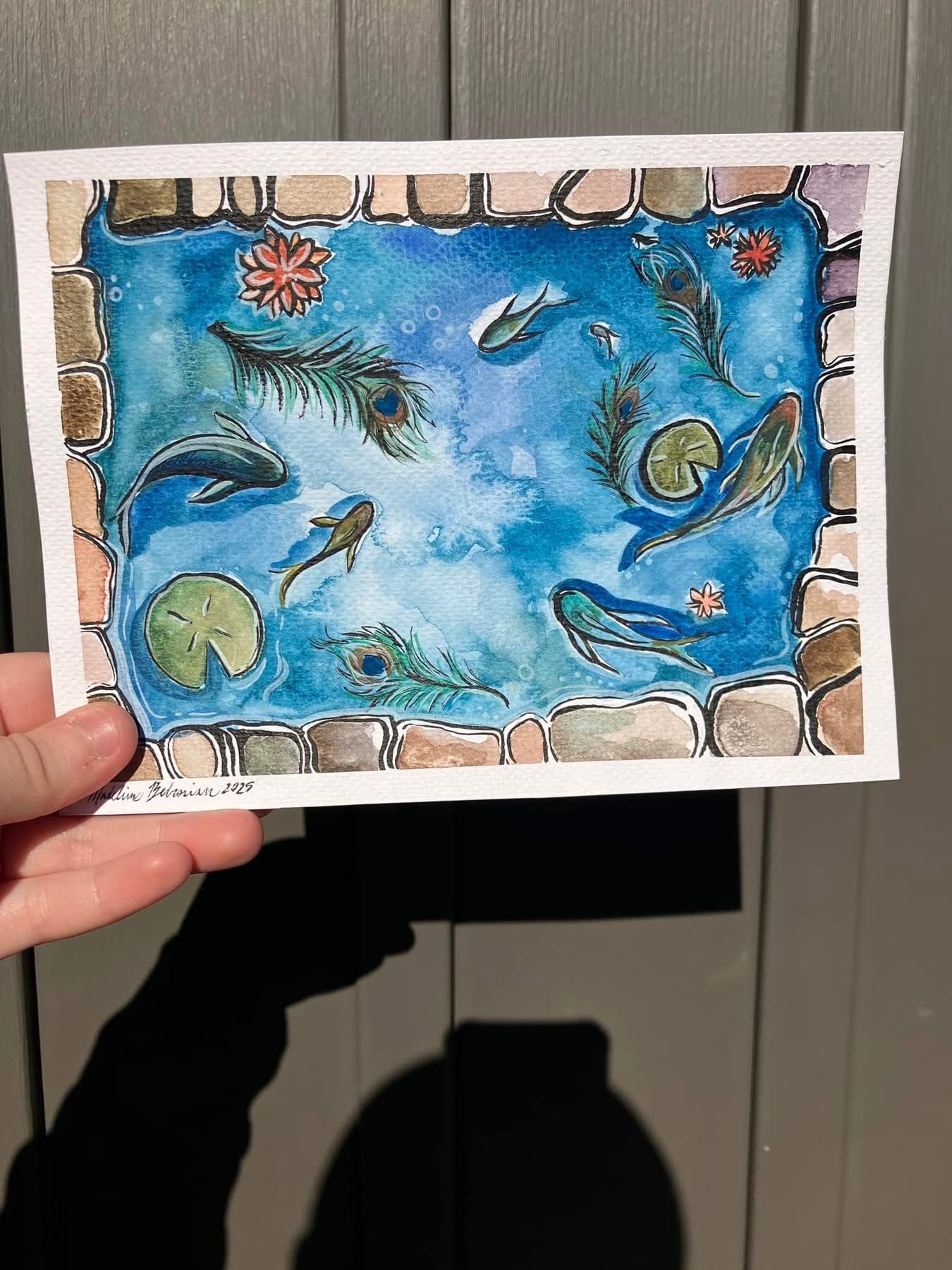 A colorful watercolor painting of a koi pond with blue water, fish, lily pads, and floating feathers, bordered by a hand-painted stone edge.