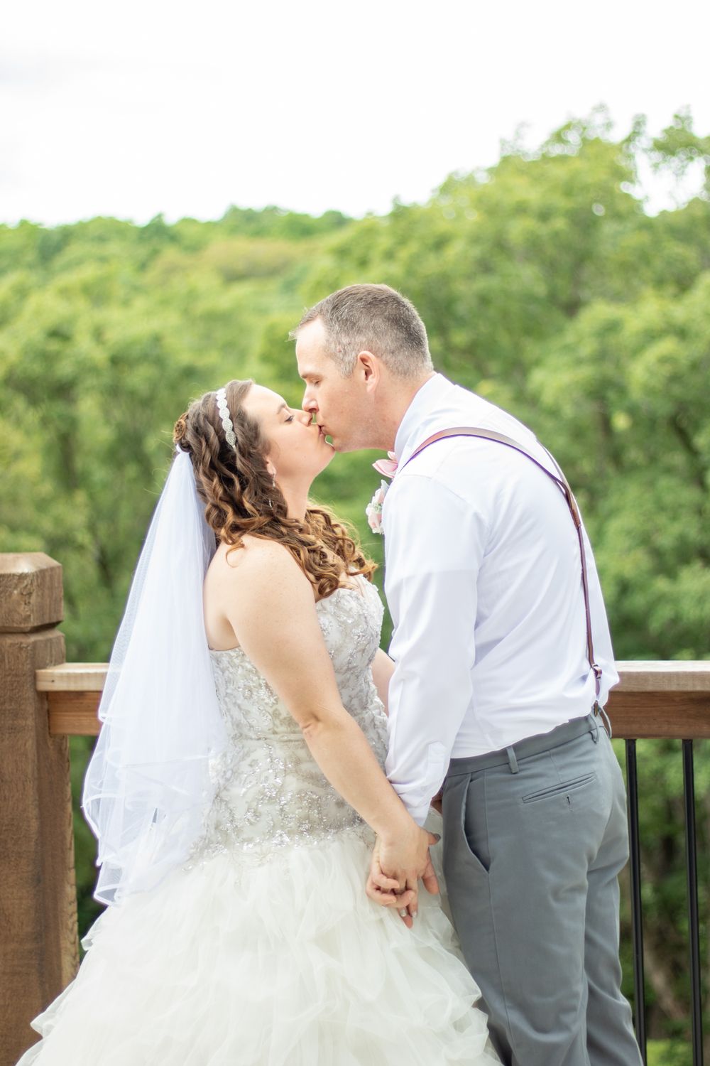 Bride and groom kissing at their outside wedding.