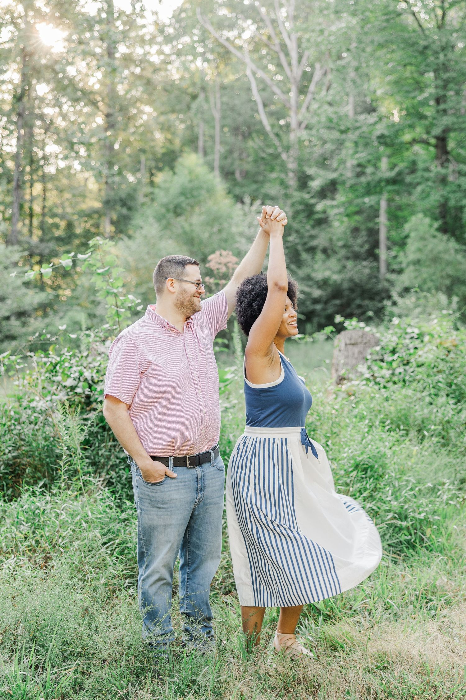 Playful dancing poses captured in outdoor summer photoshoot.