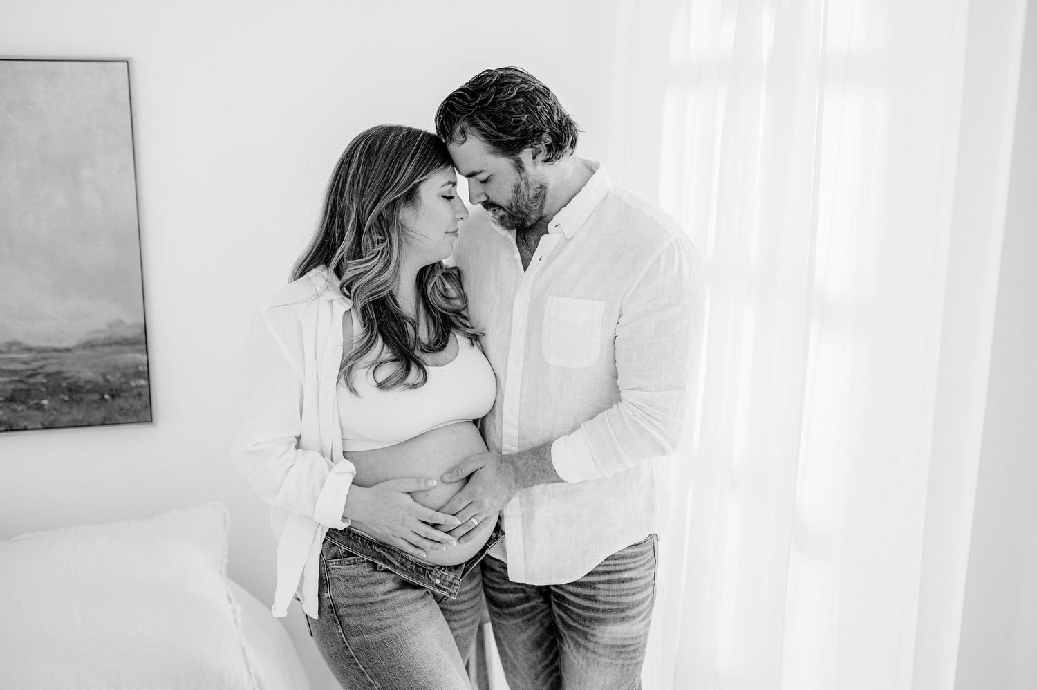 A maternity Jacksonville, FL photo session featuring romantic black and white photo showing tender moments between a couple.