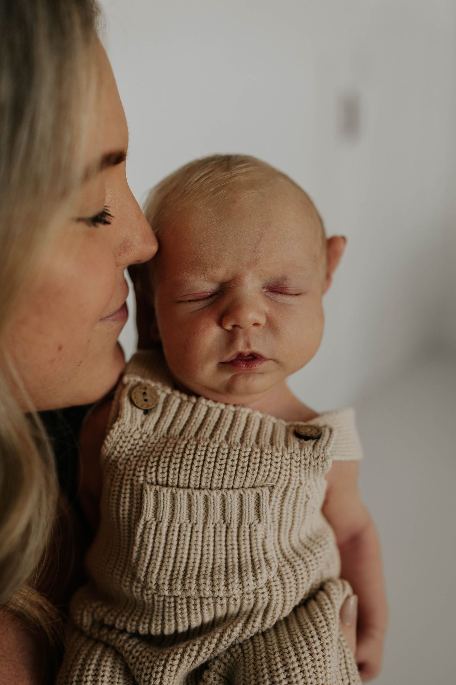 Mom and baby cuddling during studio newborn session in apple valley mn