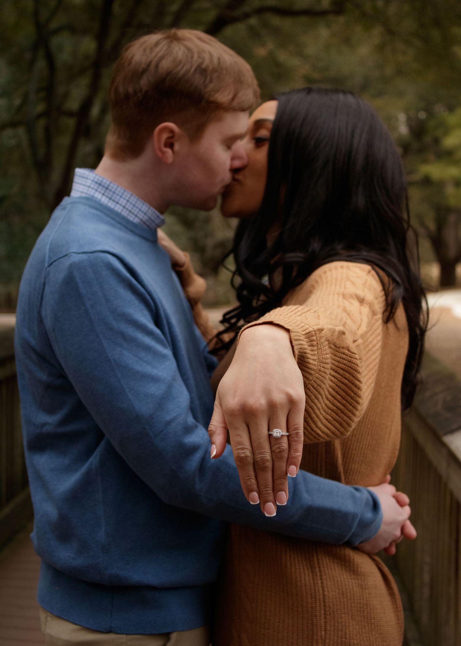 Romantic couple embraces during golden hour sunset photoshoot in desert landscape.